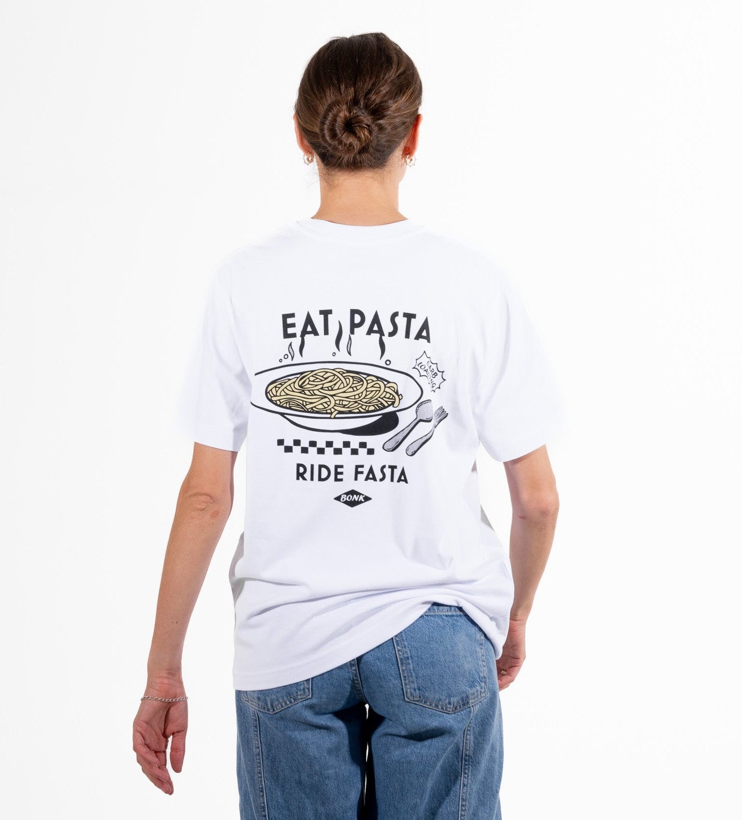 Person wearing a white t-shirt with a pasta-themed design on the back, standing against a white background.